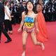 Image for article titled Activist Crashes Cannes Red Carpet to Protest Rape in Ukraine
